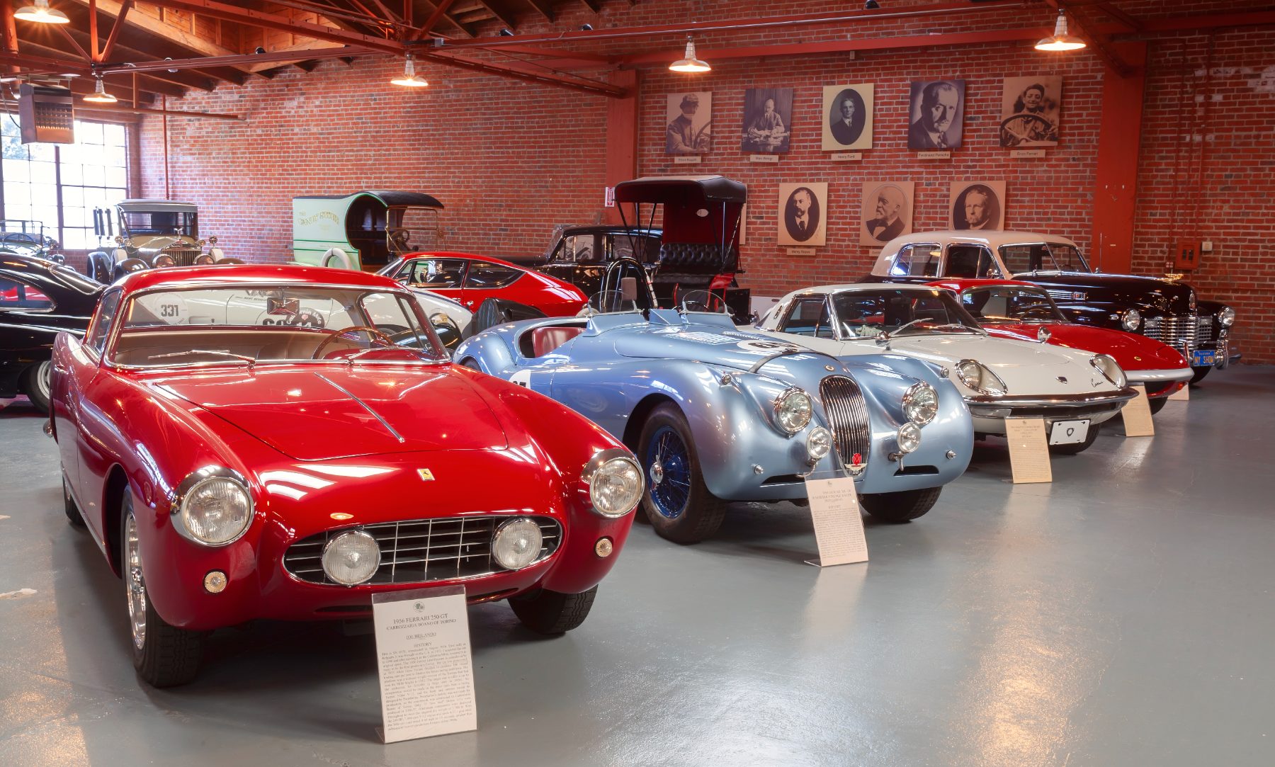 A 1956 Ferrari 250 GT and Jaguar XK120 roadster racer in the brick room