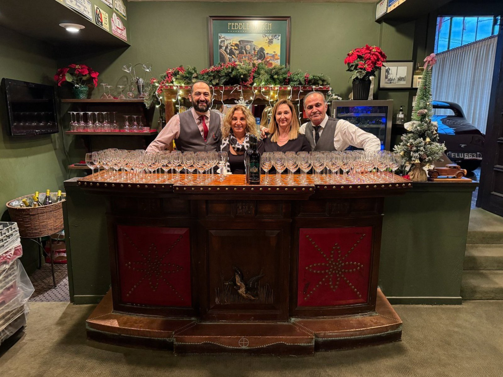 Bar staff behind the antique bar at the holidays