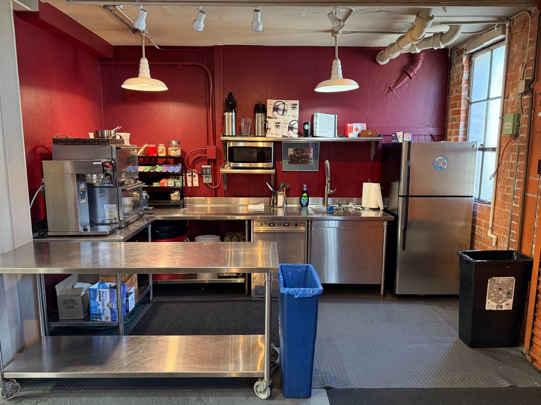The club's stainless commercial kitchen with prep tables and coffee service