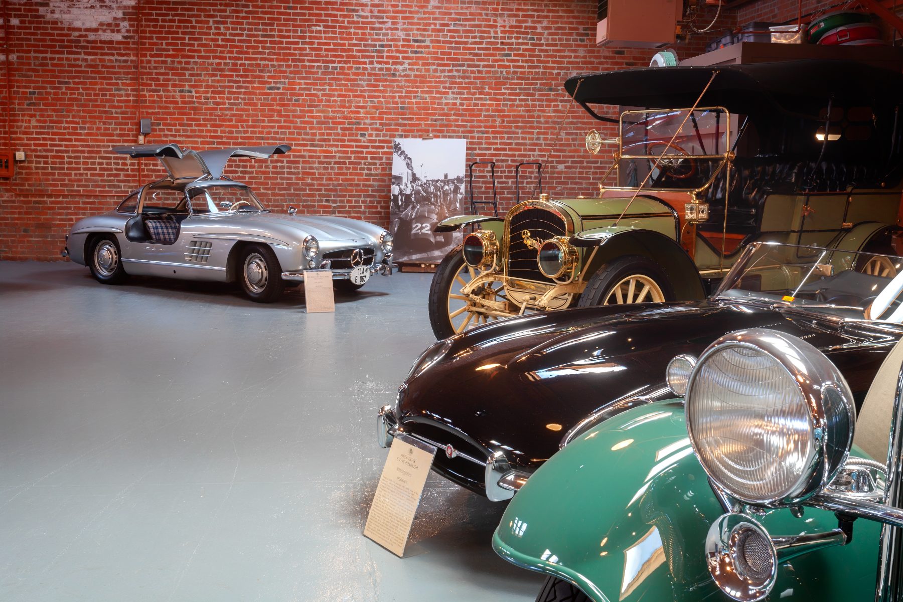 A car with its doors raised in the brick room