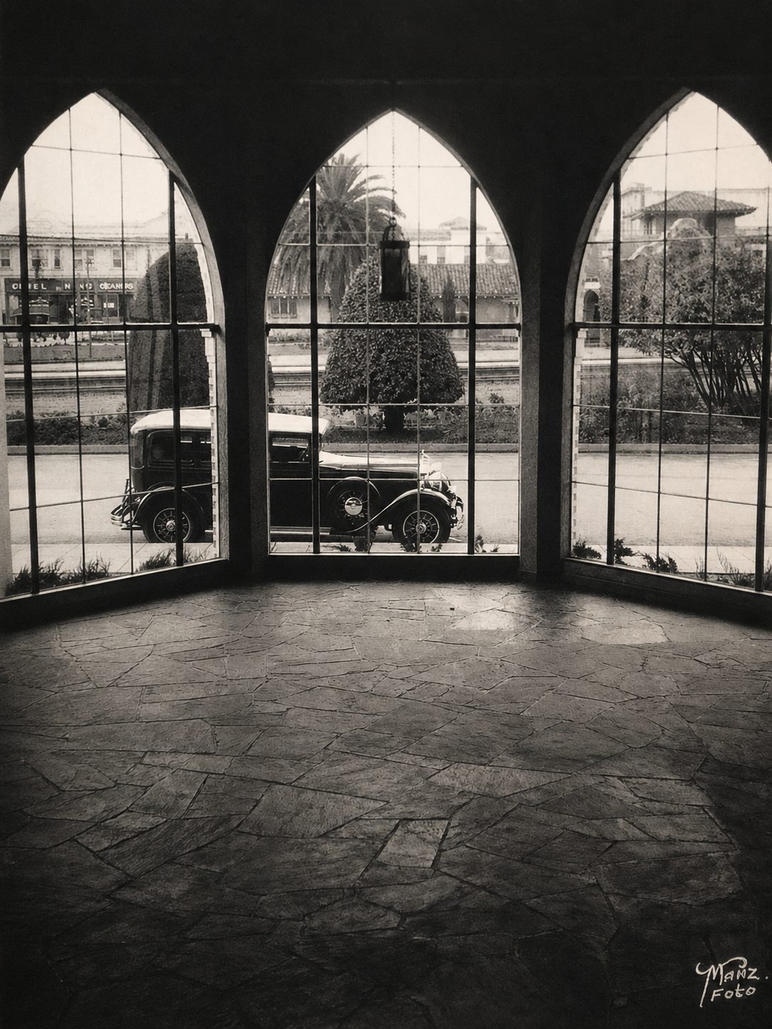 The 1928 showroom interior, arched cathedral windows looking onto the street
